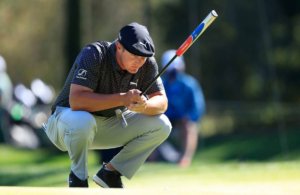 A smooth armed Bryson DeChambeau lines up a putt | Two Inches Short